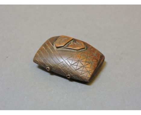 A mid 19th century Japanese boxwood netsuke, in the form of a purse, the clasps engraved kin (gold) and gin (silver)