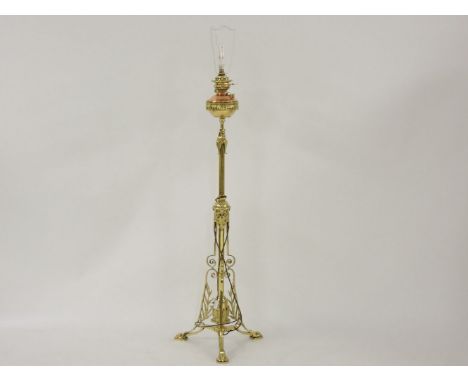 An aesthetic brass adjustable oil lamp, with a copper reservoir, now converted for electricity, 150cm high