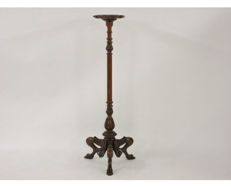 A Gothic style torchère, on an ornately carved tripod base, 147cm high