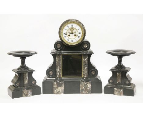 A late 19th century French black marble clock garniture, the clock with drum top, the dial with visible escapement, inscribed