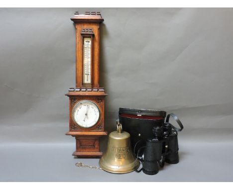 A Victorian oak barometer, a pair of binoculars, and a reproduction 'Titanic' bell