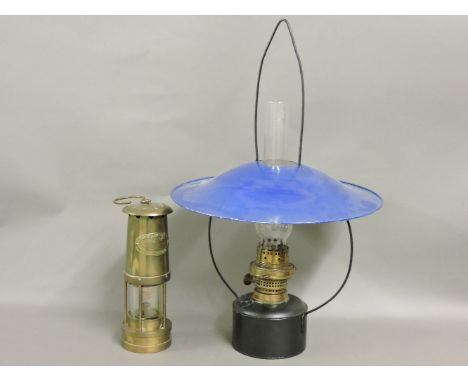 A hanging oil lamp, with chimney and blue enamel shade, and a miner's lamp by Thomas & Williams