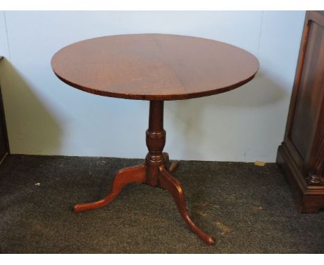 A George III figured oak tripod table, circa 1790