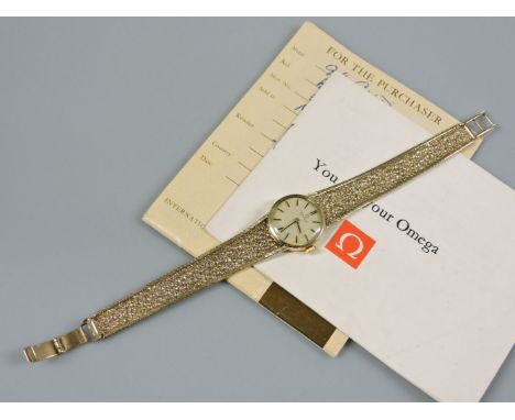 A 9ct gold Omega ladies mechanical bracelet watch, with raised gold and black enamel batons on a tapering Milanese textured b