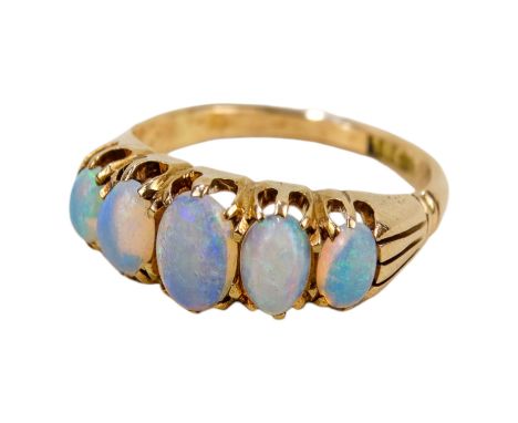 An 18ct opal set ring - of five graduated cabochon cut stones, size N, 4.3g.