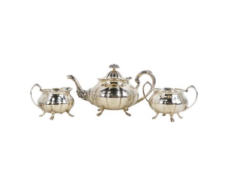 A silver three piece tea service - Sheffield 1975, Cooper Brothers &amp; Sons Ltd, of melon form and raised on paw feet, comp