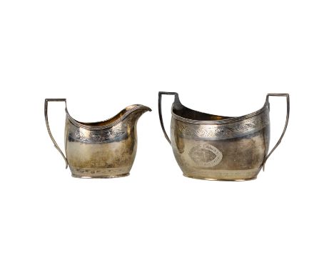 A George III helmet shaped silver cream jug - London 1786, with gilded interior and bright-cut engraving, together with a suc