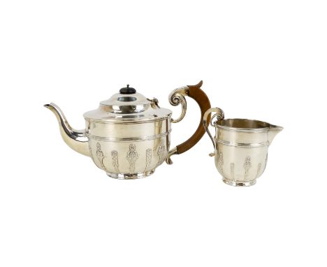 A two piece silver tea service - London 1901, the teapot with fruitwood handle, together with a matching cream jug, 789g. (2)