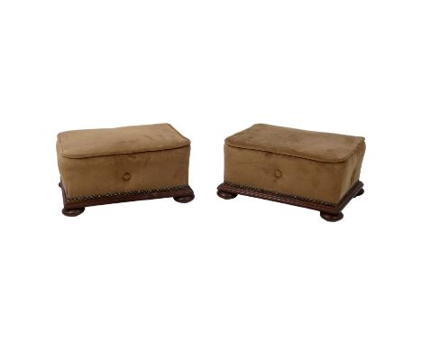 A pair of Victorian mahogany foot stools - rectangular and button upholstered in brown fabric on squat bun feet, 37cm wide. (