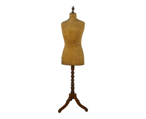 An early 20th century mannequin - with a cloth upholstered torso on a walnut pedestal tripod stand, 160cm high.