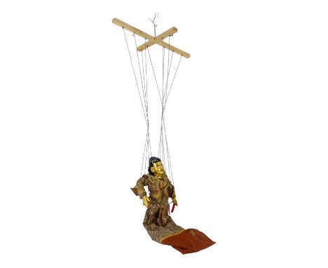 A 20th century Burmese string puppet - with gilt face and hands, wearing an exotic costume, 61cm high.
