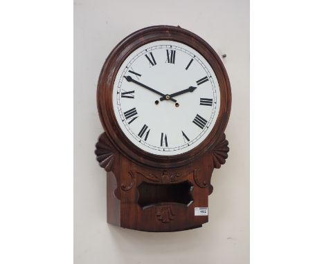 Adapted 19th century stained wall clock, moulded circular face, Roman numerals over carved squat trunk, Eight day movement st