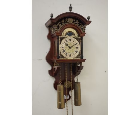 Late 20th century walnut finished moon face wall clock, moulded arched pediment mounted by finial's over foliate brass frieze