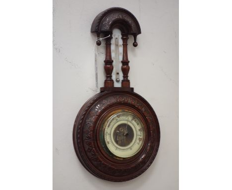 Edwardian Aneroid barometer arched pediment over trunk thermometer, flanked by baluster columns, carved circular frame and di