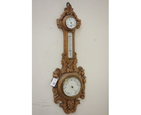 Victorian carved oak cased Barometer, foliate finial over clock, Roman numerals, trunk thermometer circular white dial surrou