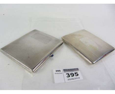 Silver engine turned cigarette case with blue cabochon catch button and scrolled ends by London Chain Bag Co Ltd, London impo