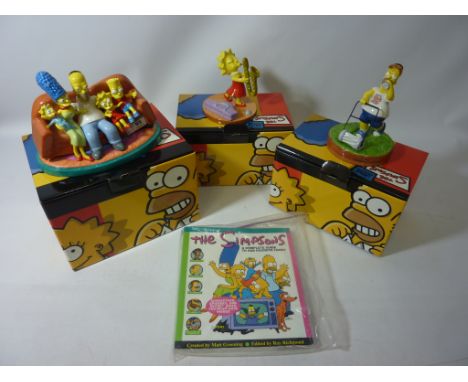 Three Coalport The Simpsons sculptures, 'The family that sits together fits together' and two other Simpson sculptures with a