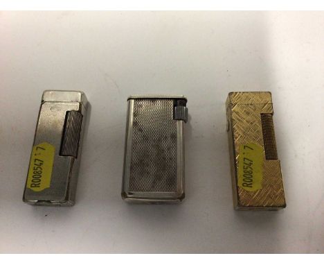 Two vintage Dunhill pocket lighters together with another (3)
