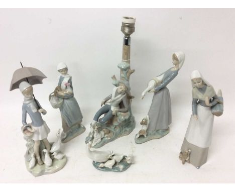 Two Lladro porcelain figures of ladies with animals, and four other Lladro or Nao porcelain ornaments including a lamp base (