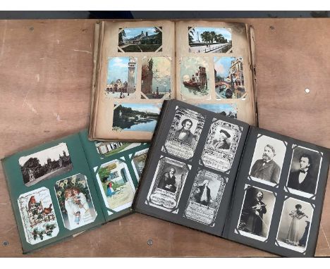 Postcards in three albums including Hold to Light Christmas, Father Christmas and other greetings, Valentine, Stamps, Officia