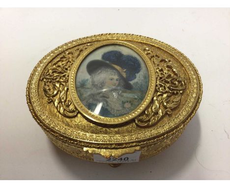 Gilt metal table box, of oval form, with signed portrait miniature painting in the centre, 15.5cm wide
