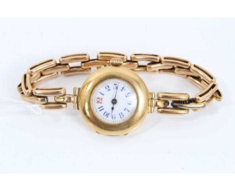 Ladies' 18ct gold wristwatch with white enamel dial and Arabic numerals, on later expanding bracelet marked 15ct.Condition re