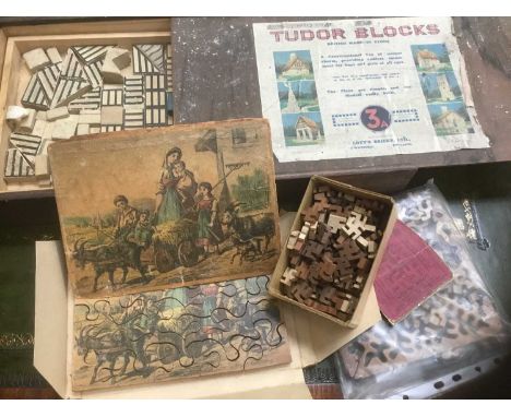 Vintage games, including 'Tudor Blocks', Lock Block, and jigsaw puzzles