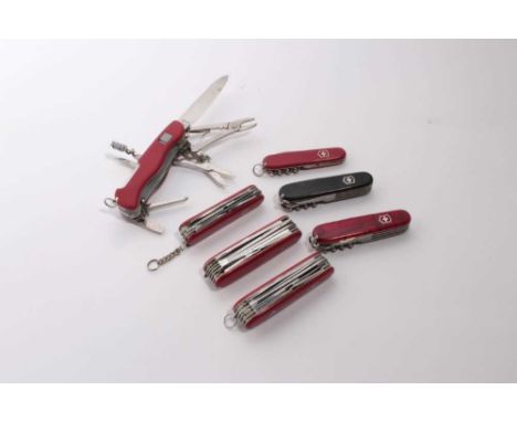 Group of seven Swiss Army folding multi bladed pocket knives (7)