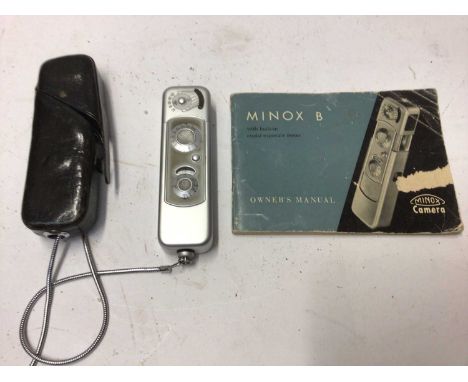 Three Minox spy cameras and accessories