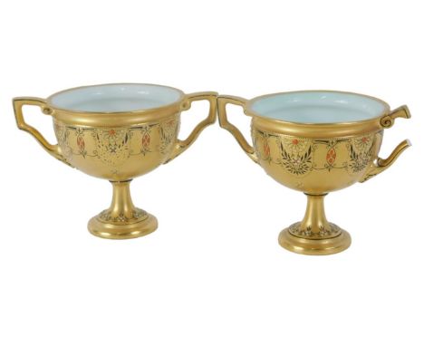 A pair of miniature Royal Worcester porcelain vases, each gilt decorated with a floral banding in black and red, on circular 