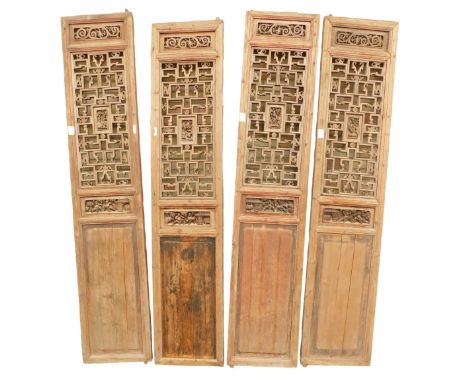 Three Chinese pine architectural screen sections, each with pierced, carved and panelled decoration, 236cm high, 49cm wide. (