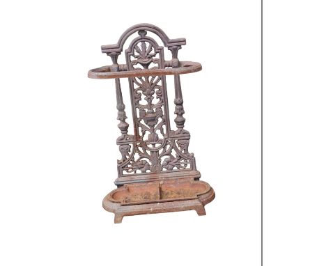 A cast metal umbrella stand, with a shaped urn and fern back, with drip tray, 58cm high, 23cm wide.