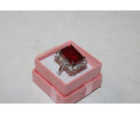 A large Sterling silver cocktail ring with red centre stone and cubic zirconia's, size K/L, approx. 8gms 