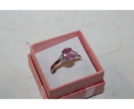 A Sterling silver ruby and white gemstone ring, ring size T/U