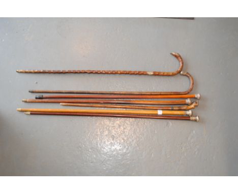 Seven vintage walking sticks and canes, some silver mounted 