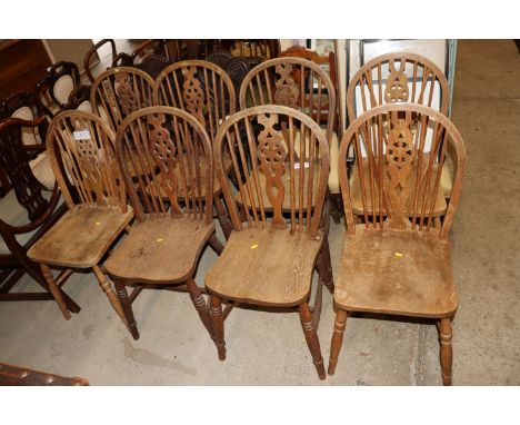 Eight elm seated stick and wheel back dining chairs (one AF)
