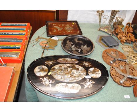 A Chinese mother of pearl inlaid wall plaque AF; a circular lacquered pedestal dish; an Oriental mother of pearl inlaid hardw