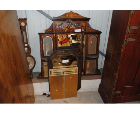 An Edwardian rosewood and inlaid overmantel mirror; a 19th Century mahogany Chippendale style wall mirror with Ho Ho bird mot