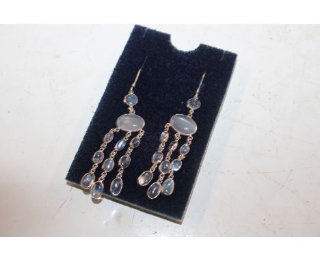 A pair of long drop silver and moonstone chandelier ear-rings 