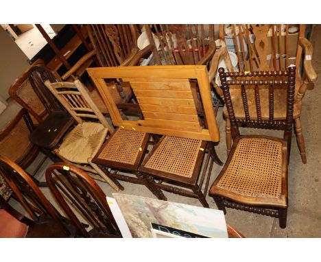 A Victorian bobbin framed nursing chair; a pair of cane seated bedroom chairs; a rush seated spindle back chair; and a single