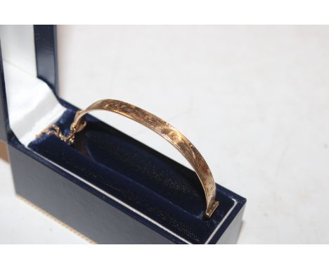 A vintage HG&amp;S 9ct gold and metal core hinged bangle, approx. total weight 12gms