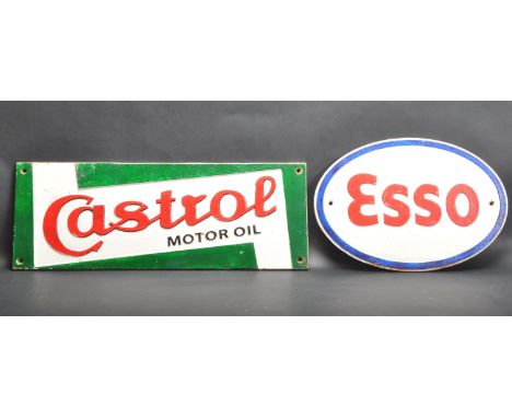 Two vintage style cast iron automotive / automobile advertising sign. A Esso sign of an oval form and a rectangular Castrol s