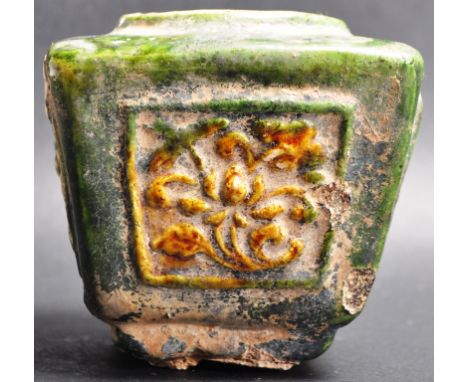 An 18th century Chinese oriental stoneware brush pot. The pot of a square form with tapered body having raised floral motifs 