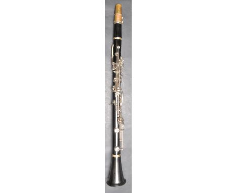 A vintage mid 20th century French ebonised wooden clarinet having a flared end with chrome metal keys. Stamped M Martin to th