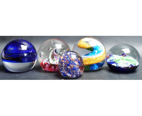 A collection of five vintage 20th century studio art glass paperweights comprising of Caithness Starry Night and more. Collec