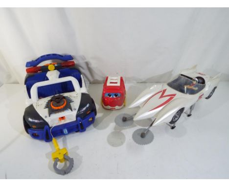 An Art Asylum Speed Racer MACH 5 Deluxe vehicle with Action Figure, also included in the lot is a Mattel model Police Car and