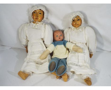 Vintage dolls - a composition headed doll with fabric limbs and torso approximately 40 cm (h) and two composition straw fille