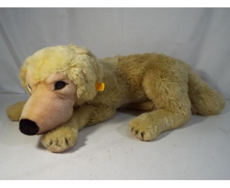 Steiff - unboxed Golden Retriever with yellow tag and button in ear, approx 21 cm (h) #667831. Estimate £20 - £40