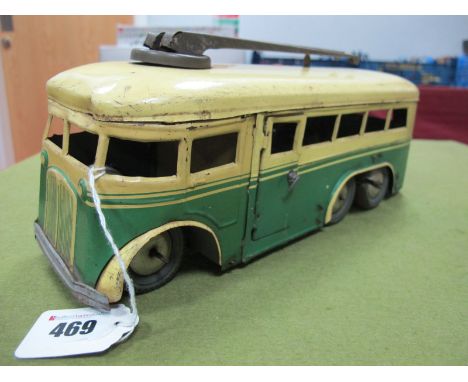 A Mid XX Century Tinplate Model of a Trolley Bus by Joustra of France, clockwork, six wheel finished in cream/green, opening 