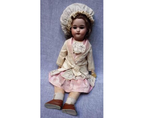 AN  EARLY 20TH CENTURY DOLL with a ceramic head stamped "1908 DEP W&Co 121 AM 5" with composite body and mostly original clot